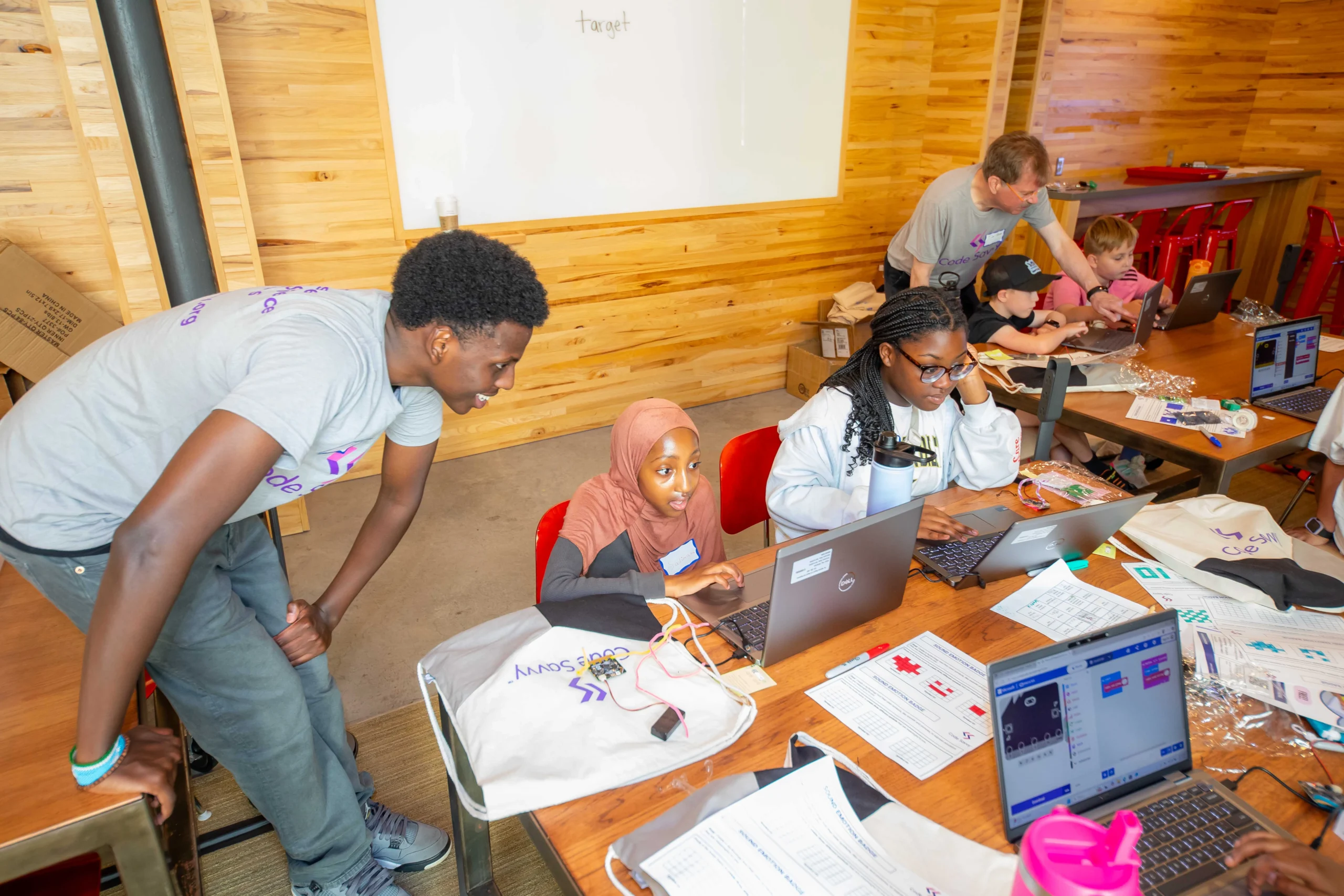 Volunteer helping students during Innovate for Good