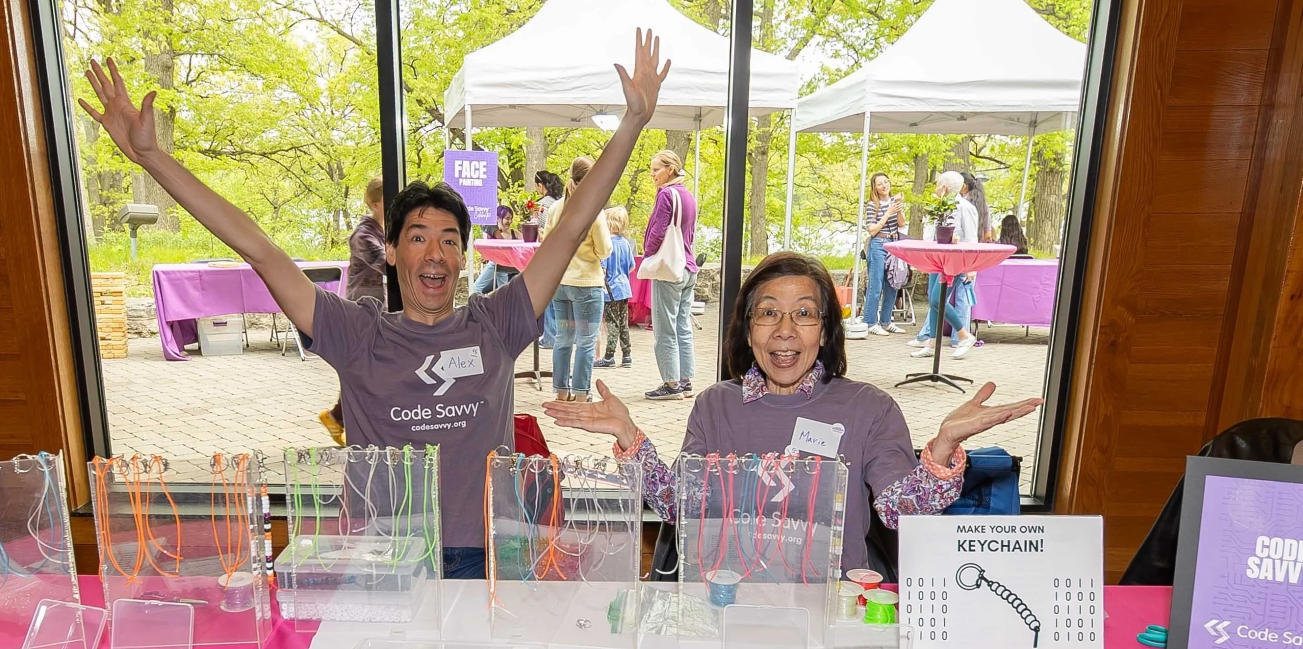Two Code Savvy volunteers at a table