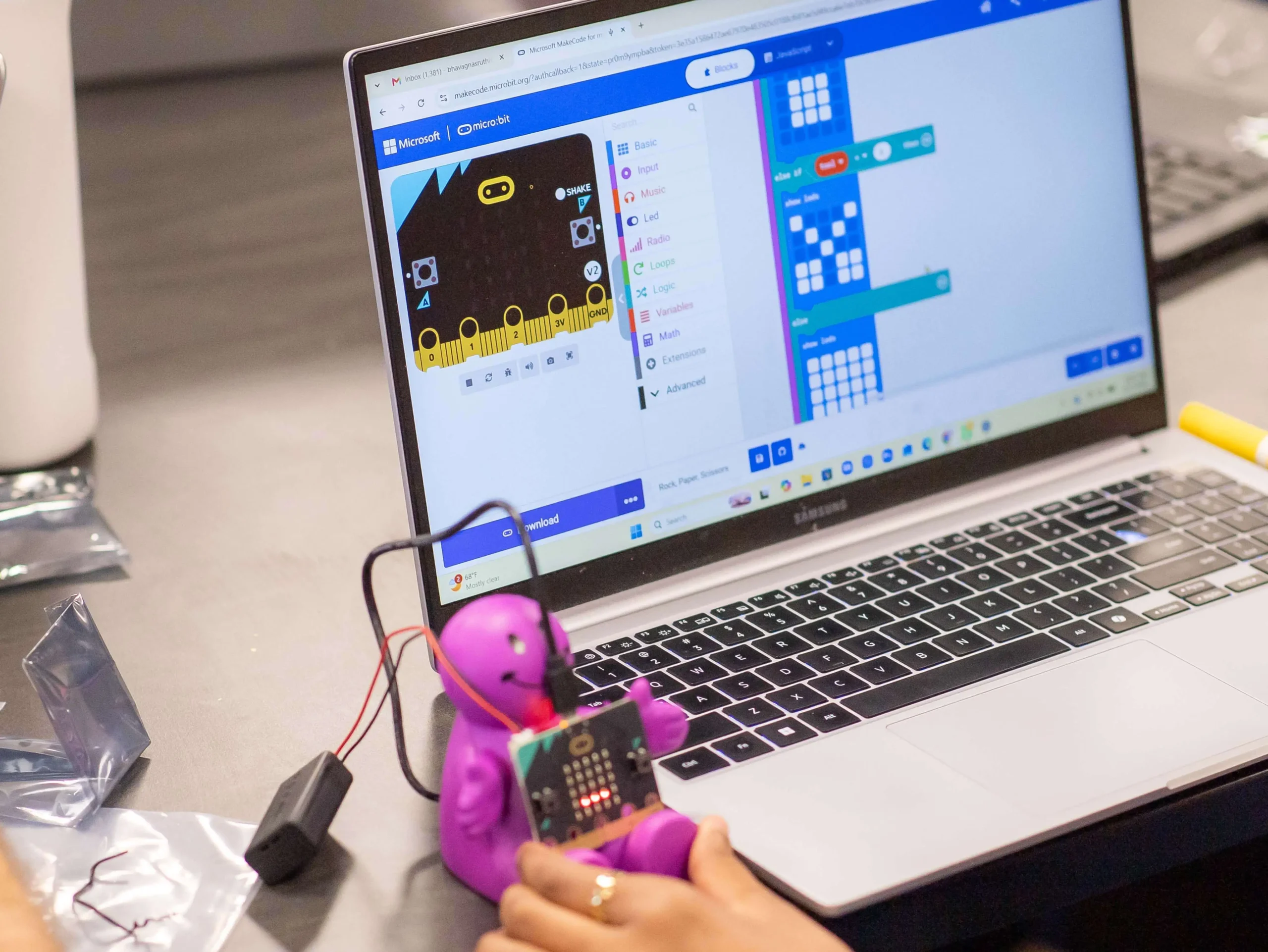 A micro:bit connected to a laptop during a Code Savvy activity.