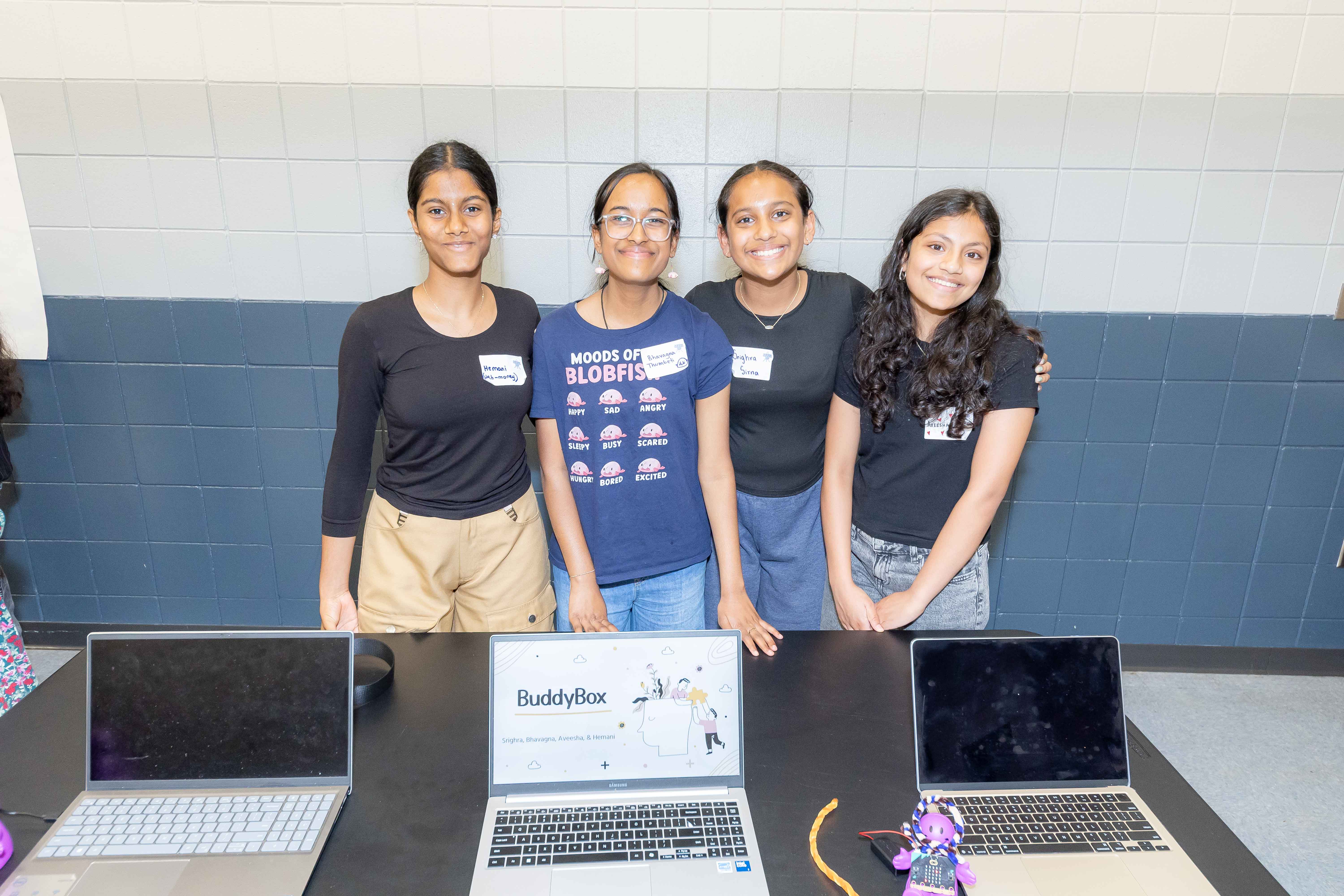 Four students presenting their project at a Code Savvy hackathon