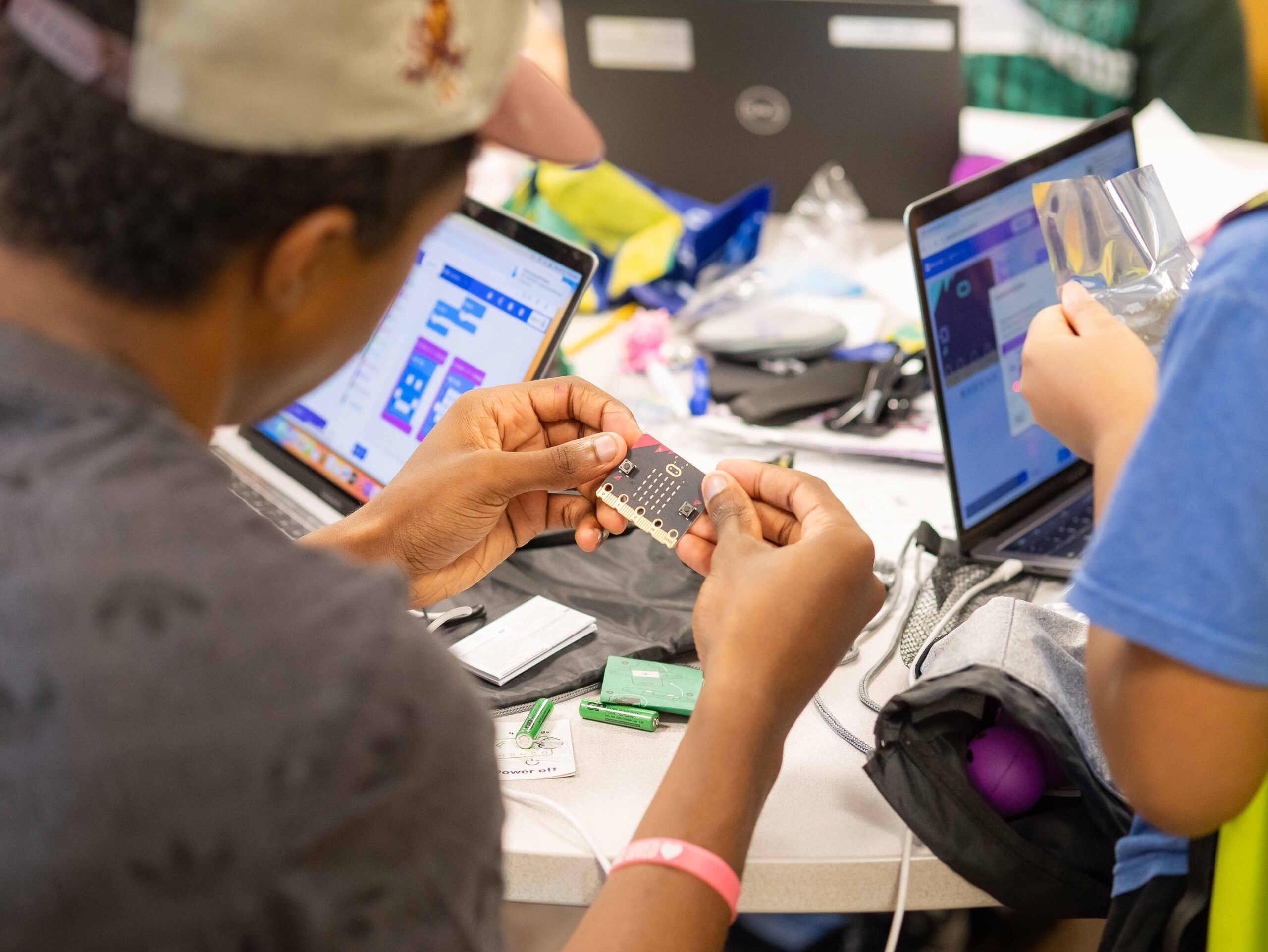 Student working with a micro:bit during a Code Savvy activity